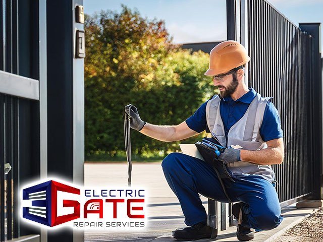 technician repairing commercial electric gate