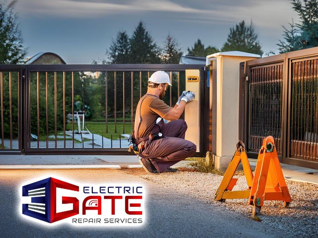 electric gate repair male technician performing emergency gate repair