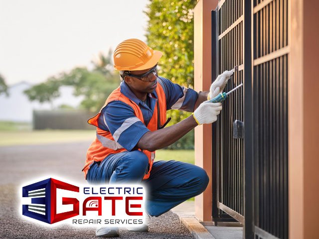 male professional technician performing electric gate maintenance