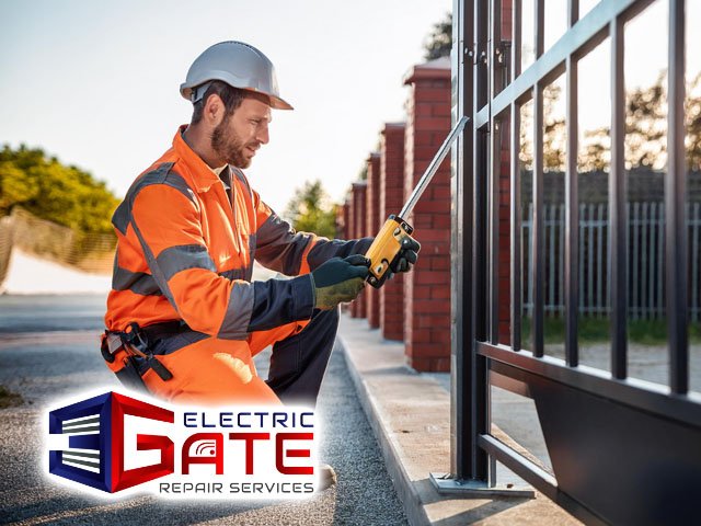 male professional technician performing emergency gate repair service